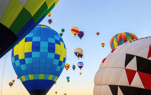 Low angle shot of airborne multi colored hot air balloons